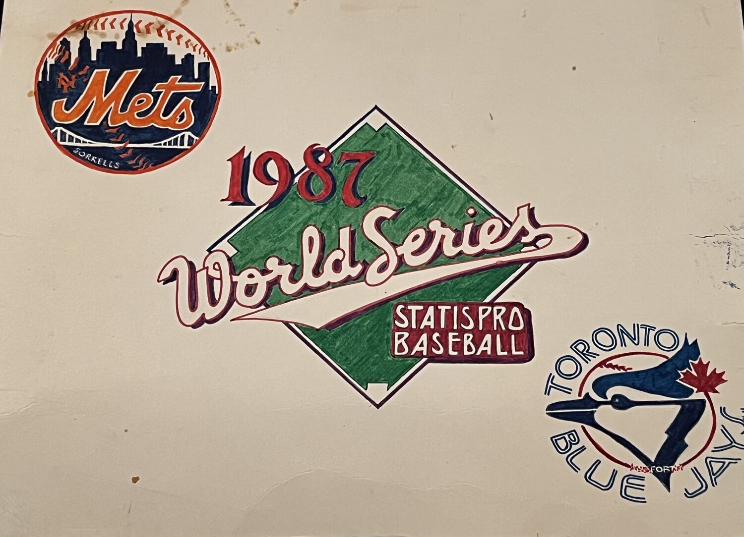 Gary's hand-drawn 1987 World Series cover for our Statis Pro Fall Classic: a hand-colored Mets logo marked "Sorrells," a "1987 World Series — Statis Pro Baseball" diamond crest, and a Toronto Blue Jays logo, on aged paper.